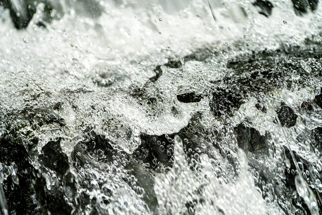 A black and white photo of water and rocks